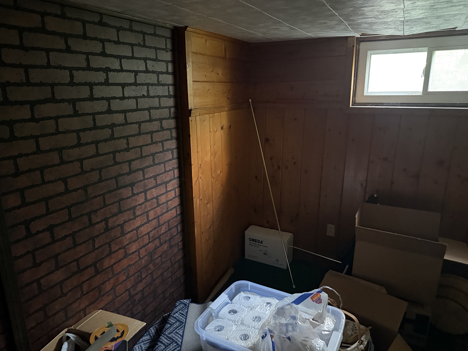 Ashland MA basement before selective demolition with wall paneling and flooring still installed